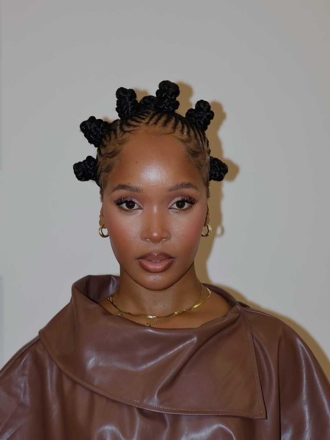 Woman with small Bantu knots arranged across her scalp