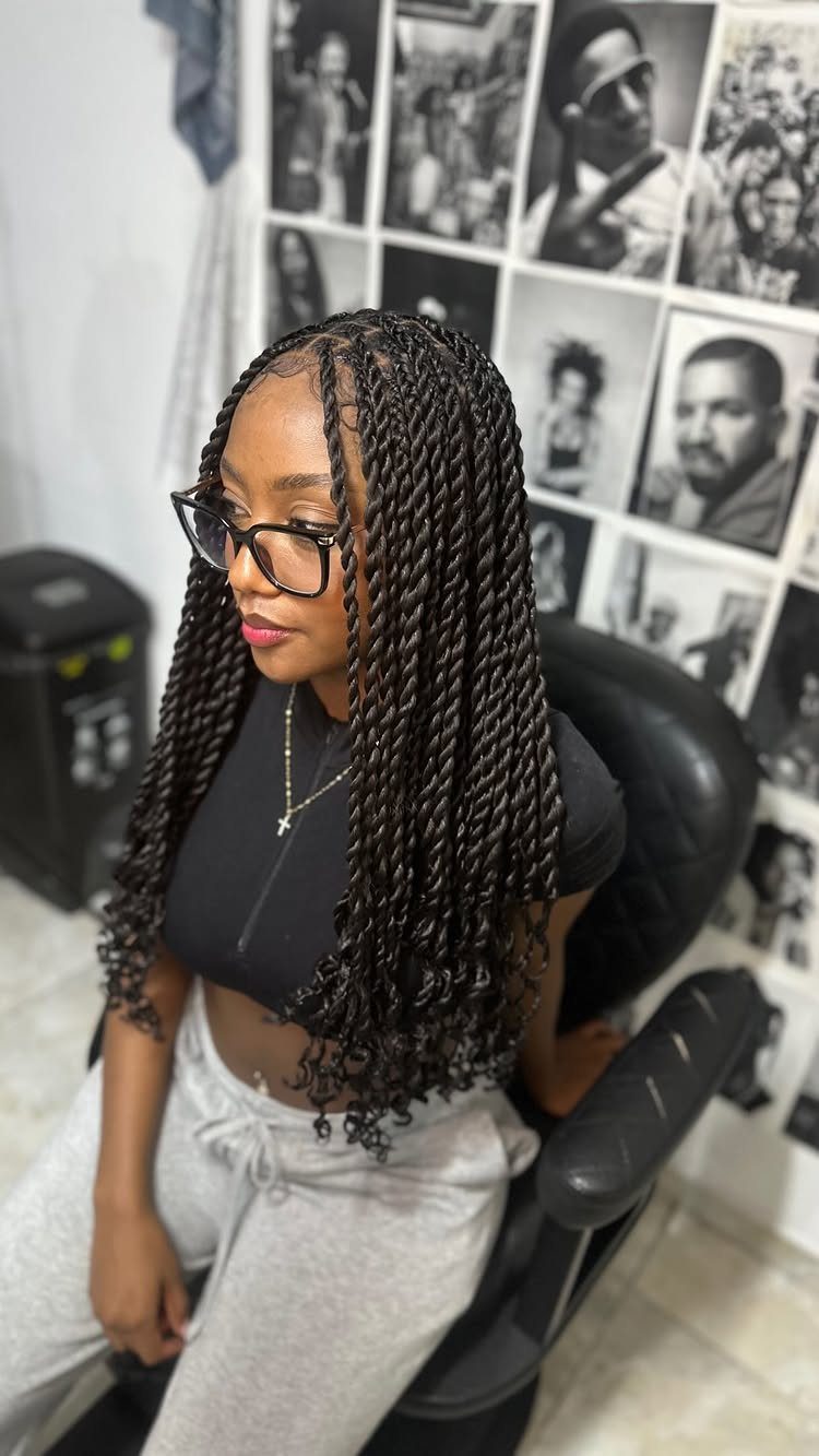 Woman with long Senegalese twists sitting in a salon chair