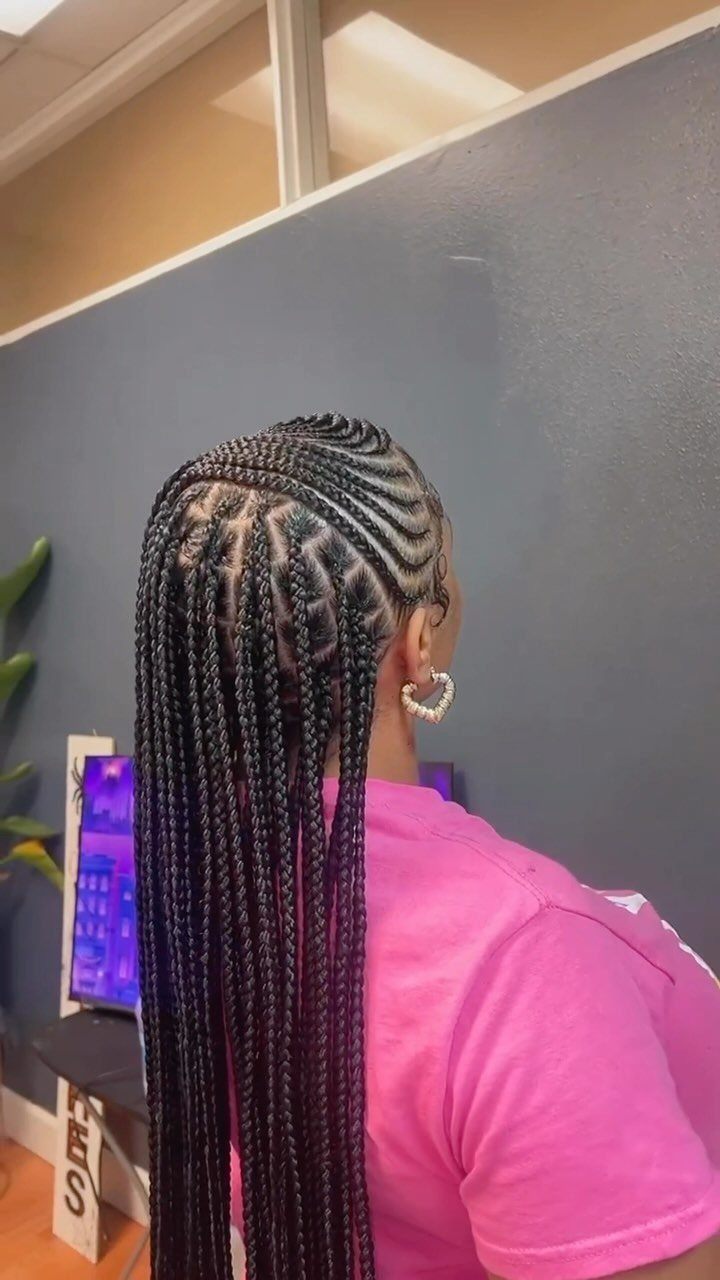 Long black braids with asymmetrical tribal cornrows seen from behind