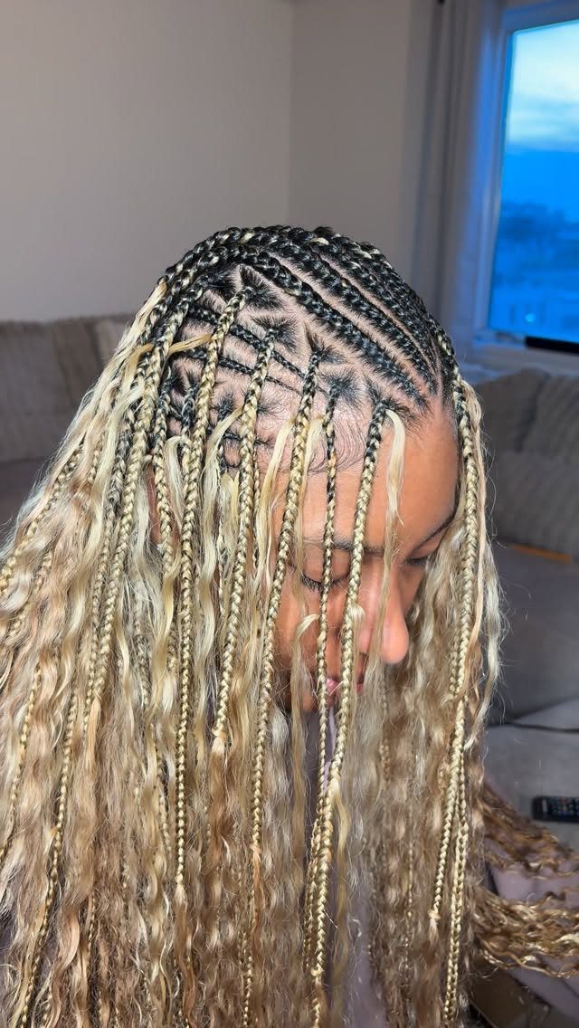 Blonde Fulani braids transition from dark cornrows into long wavy braids