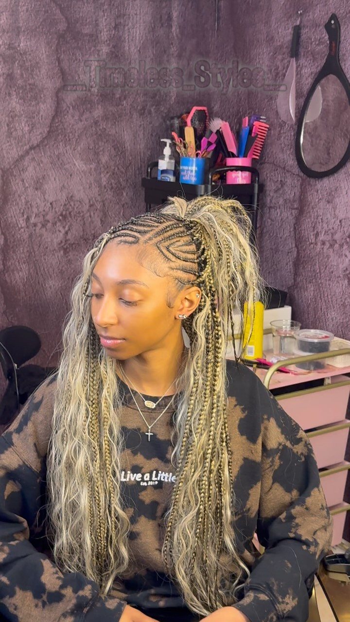 Woman wearing long boho braids with loose curls in a salon