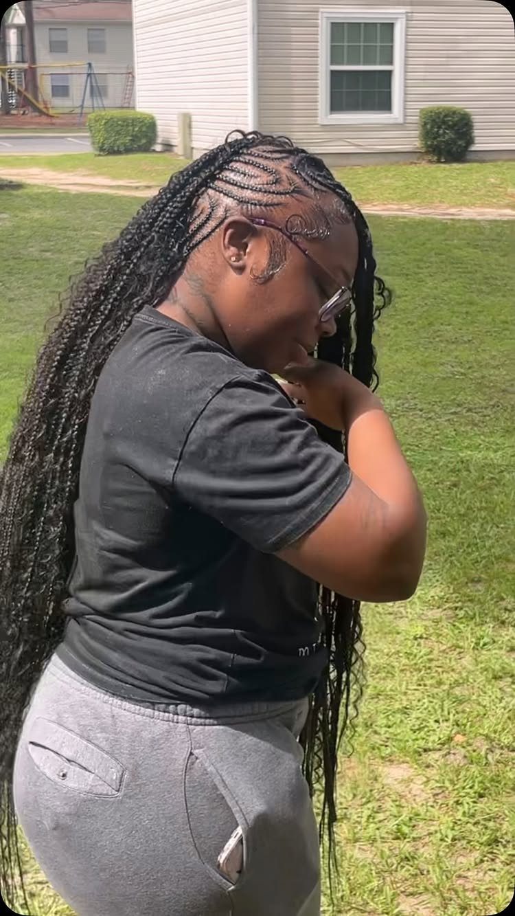 Long black braids gathered into a mohawk-style look with closely braided sides