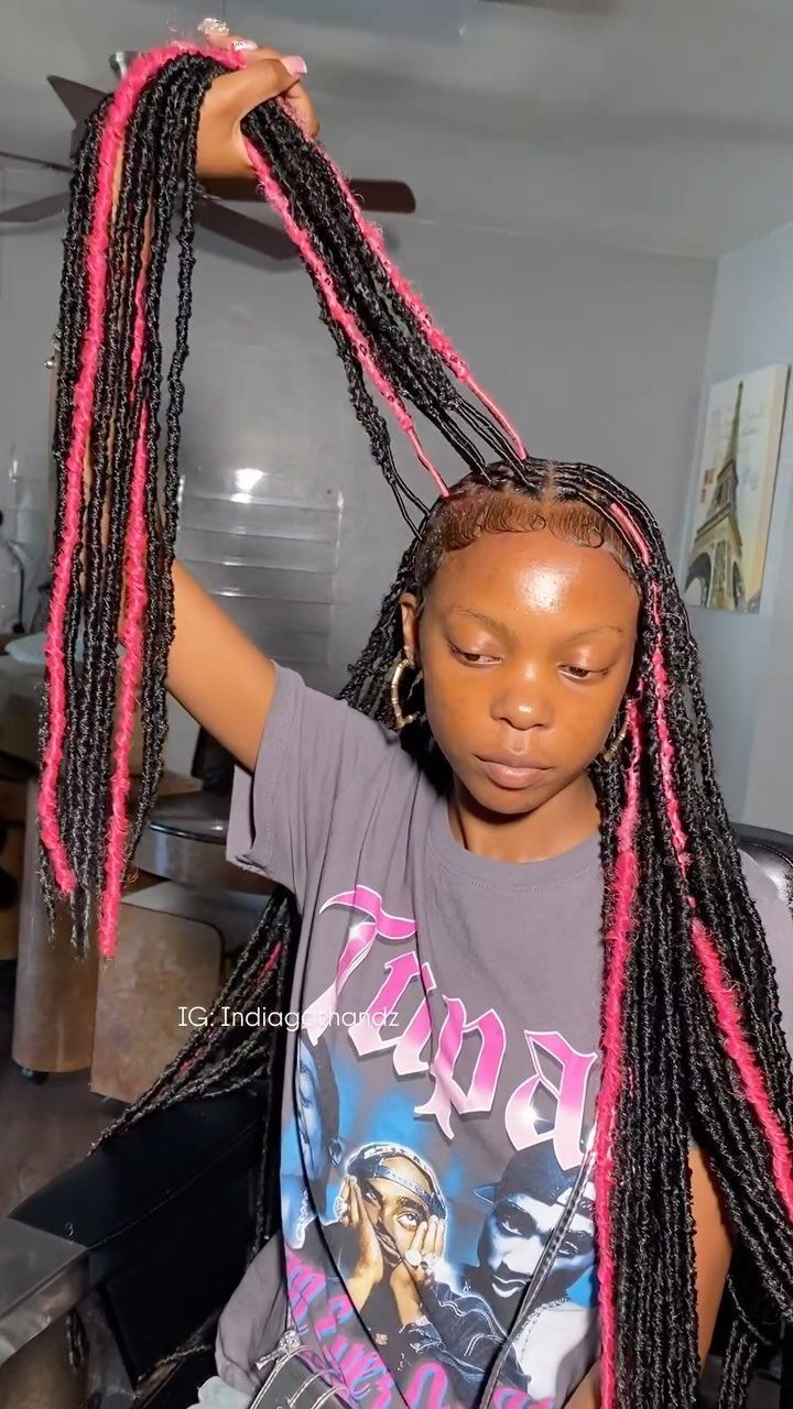 Woman lifting long black and pink faux loc extensions over her head