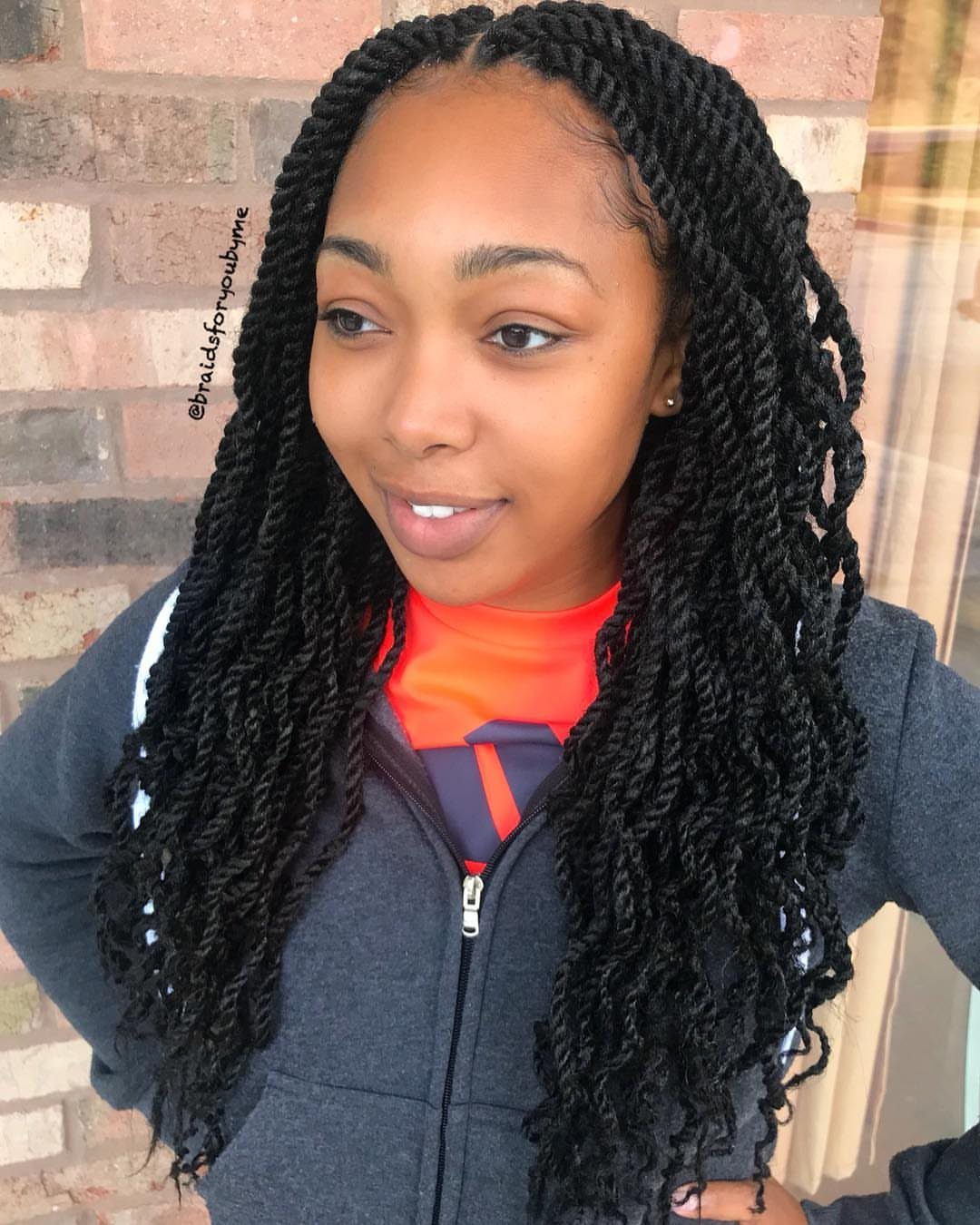 Woman with long, thick black Marley twists and textured curly ends