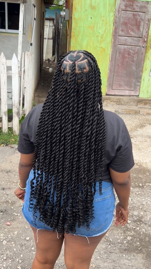 Long black twists with neat square parts fall down the back