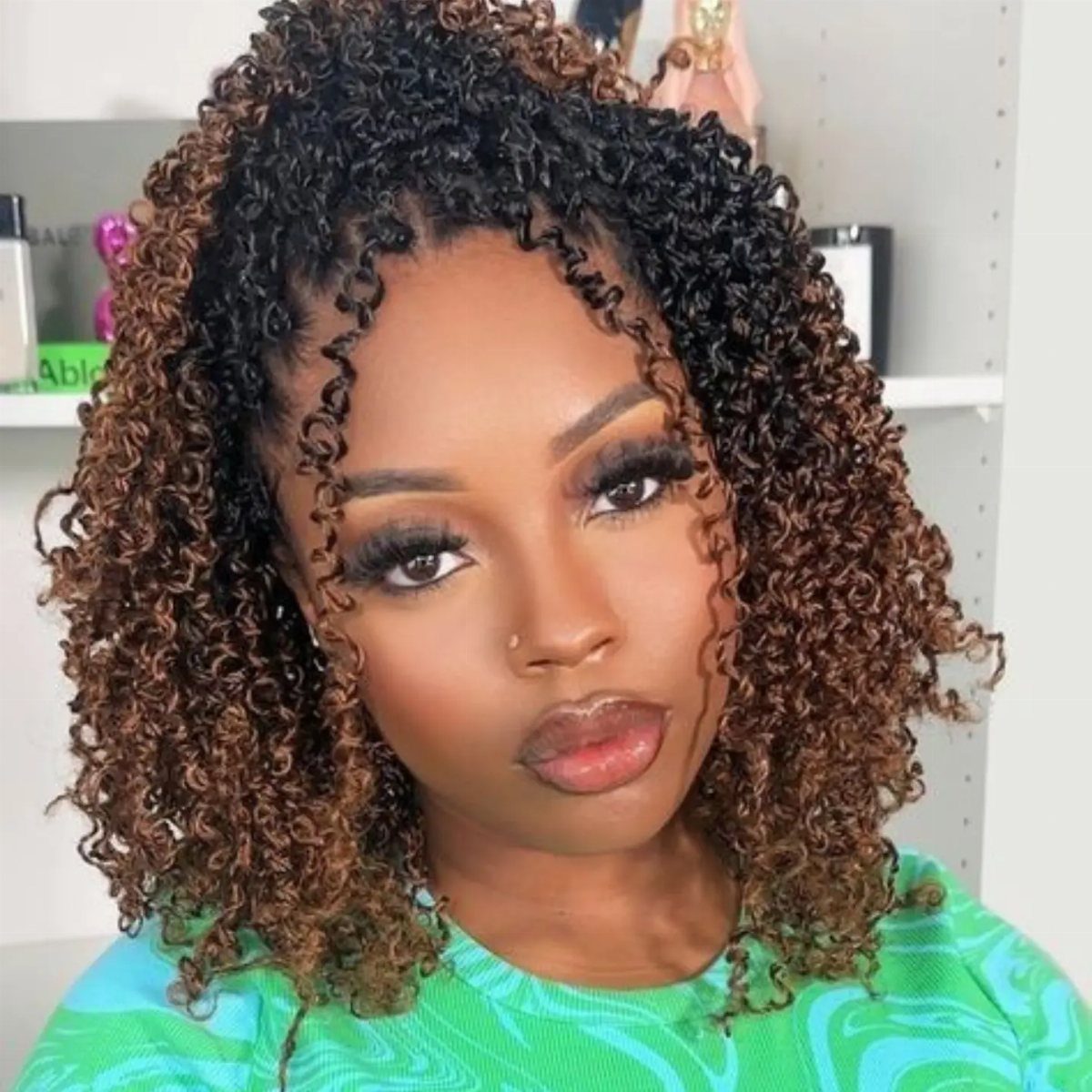 Woman with shoulder-length spring twists in black and brown curls