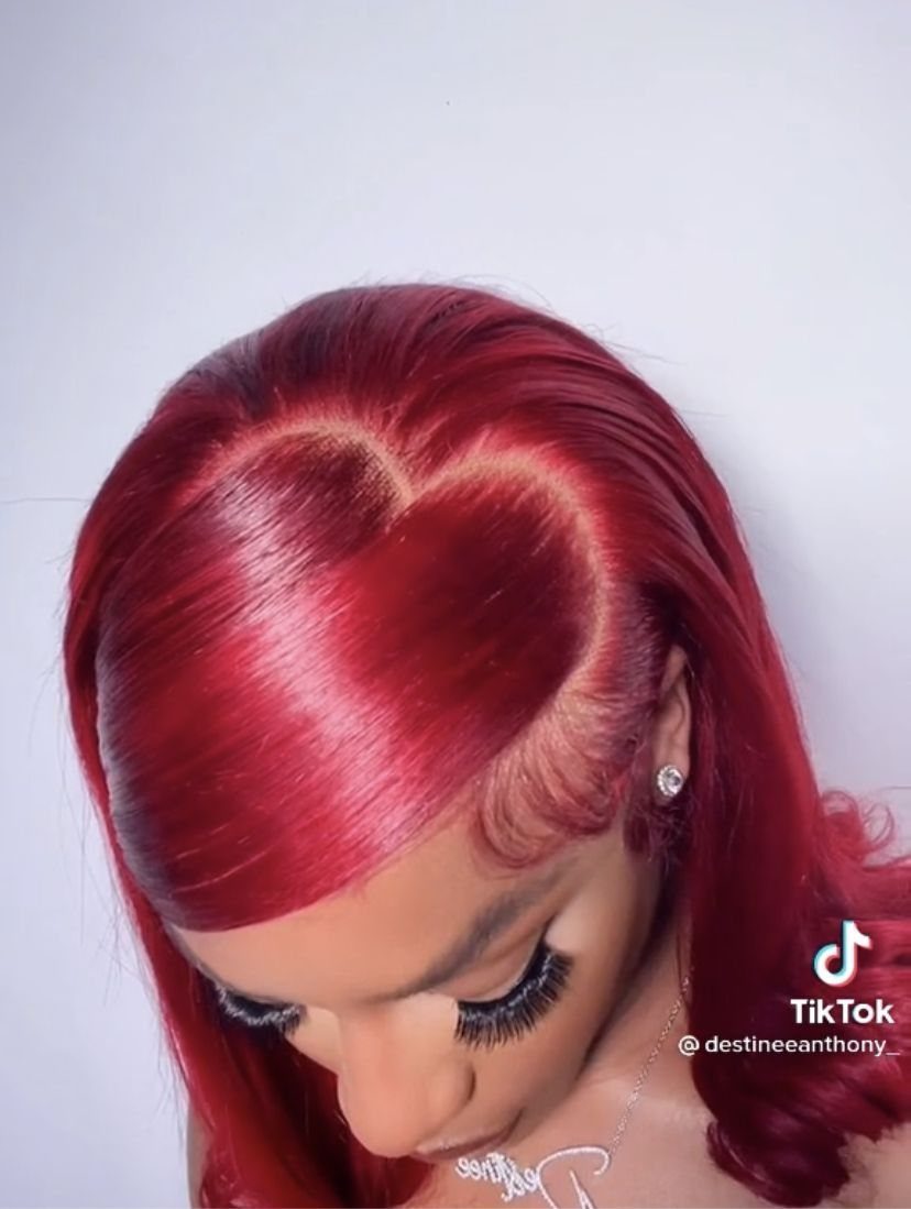 Cherry-red hair styled with a large heart-shaped parting and curled ends