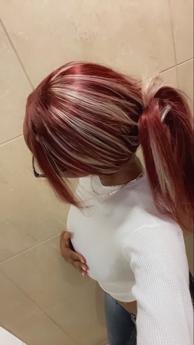 Cherry-red high side ponytail with pale pink streaks against beige tiled walls