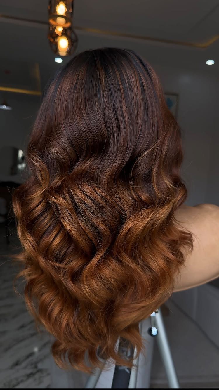 Wavy dark brown hair fading into glossy chestnut reddish-brown ends