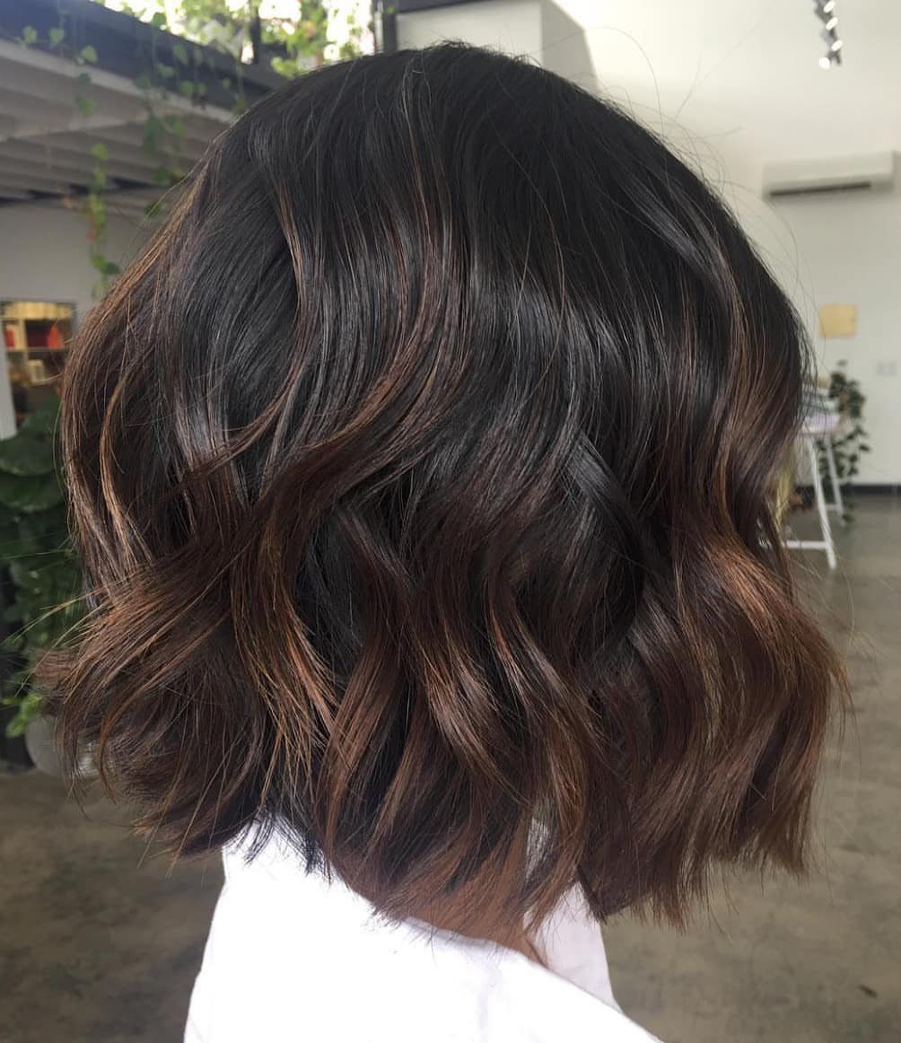 Wavy dark chocolate-brown bob with subtle lighter brown highlights