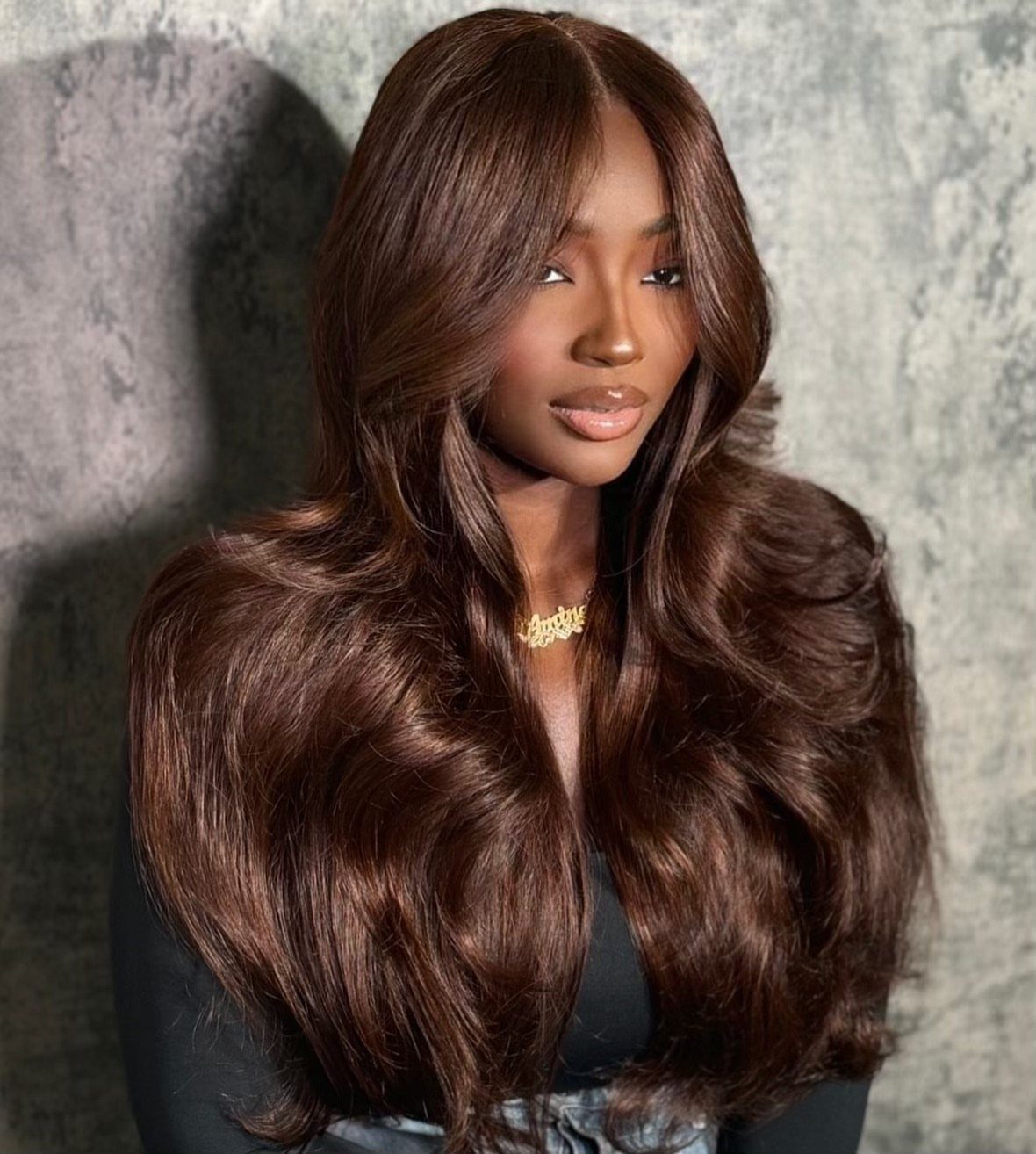 Woman with long, glossy cocoa-brown hair styled in voluminous loose waves