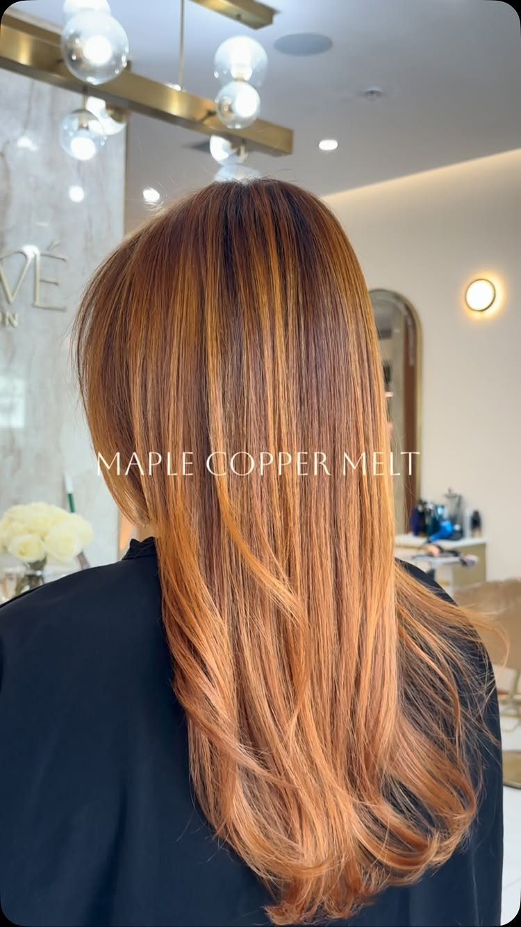 Long brunette and copper hair blended in ribbons and styled in loose waves