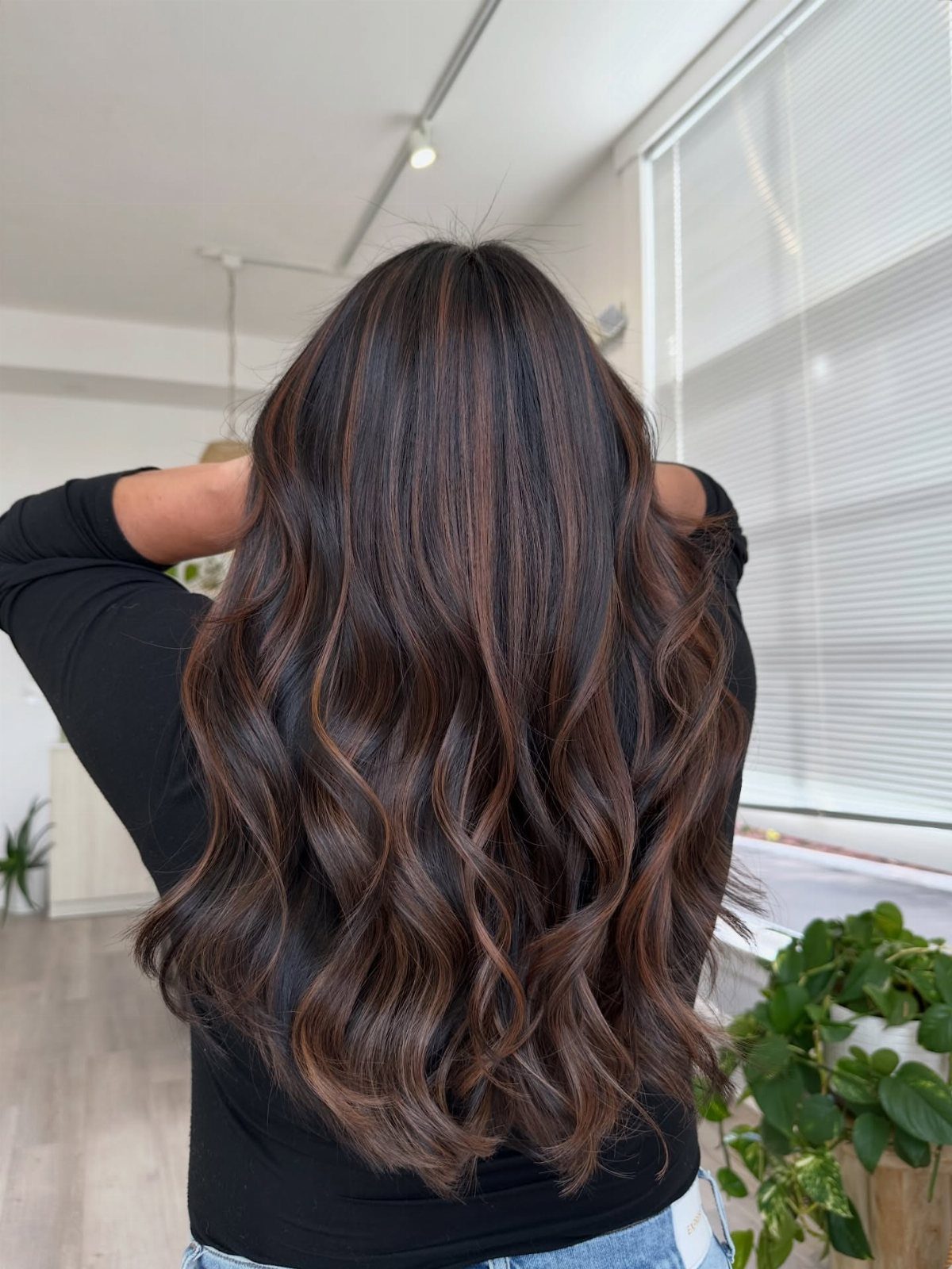 Long dark brown waves show fine bronze highlights throughout