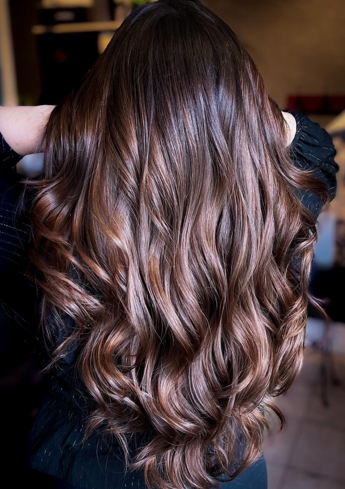 Long dark brown waves with softly blended lighter brown tones and warm highlights