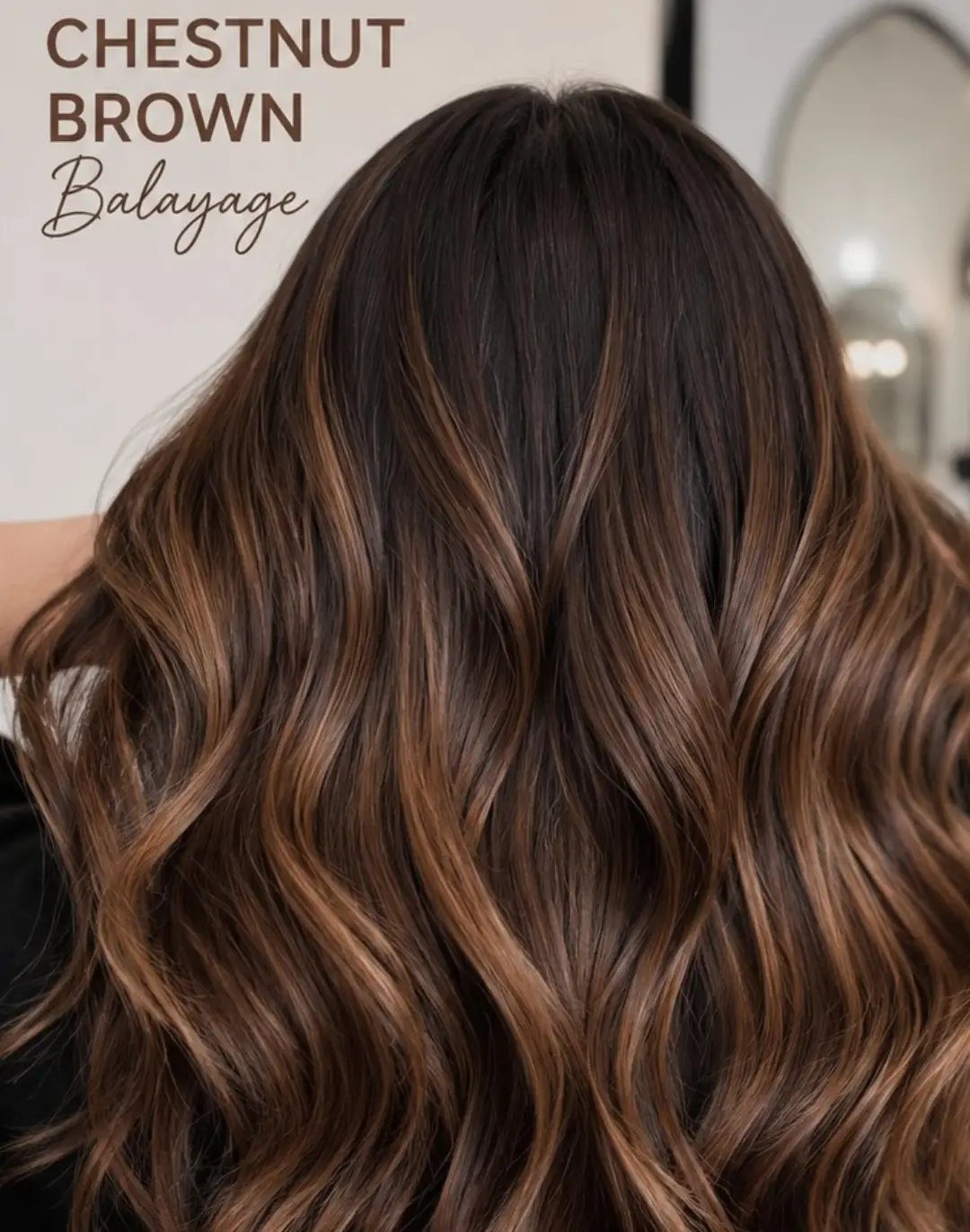 Wavy chestnut brown hair with golden balayage strands viewed from behind