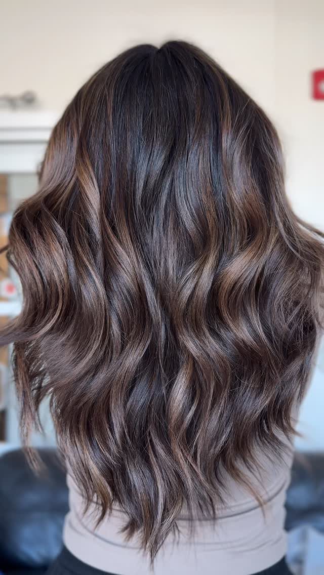 Long dark auburn-brown balayage waves with subtle highlights
