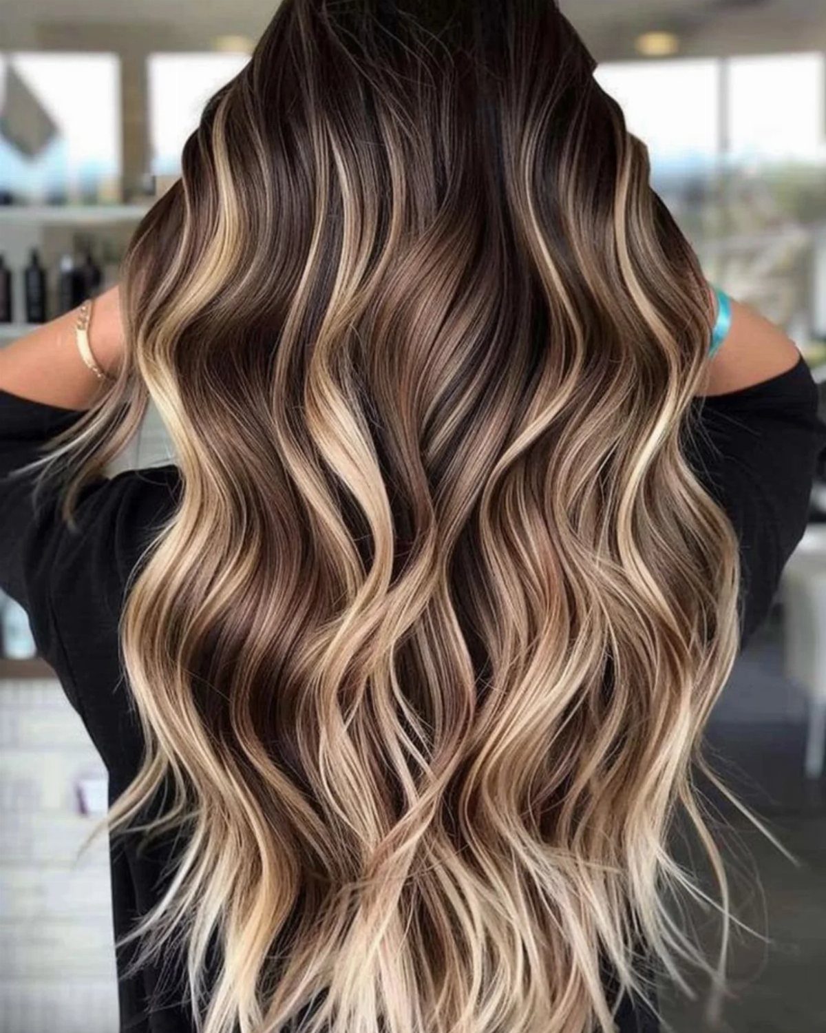 Long brunette waves with broad honey-blonde balayage highlights
