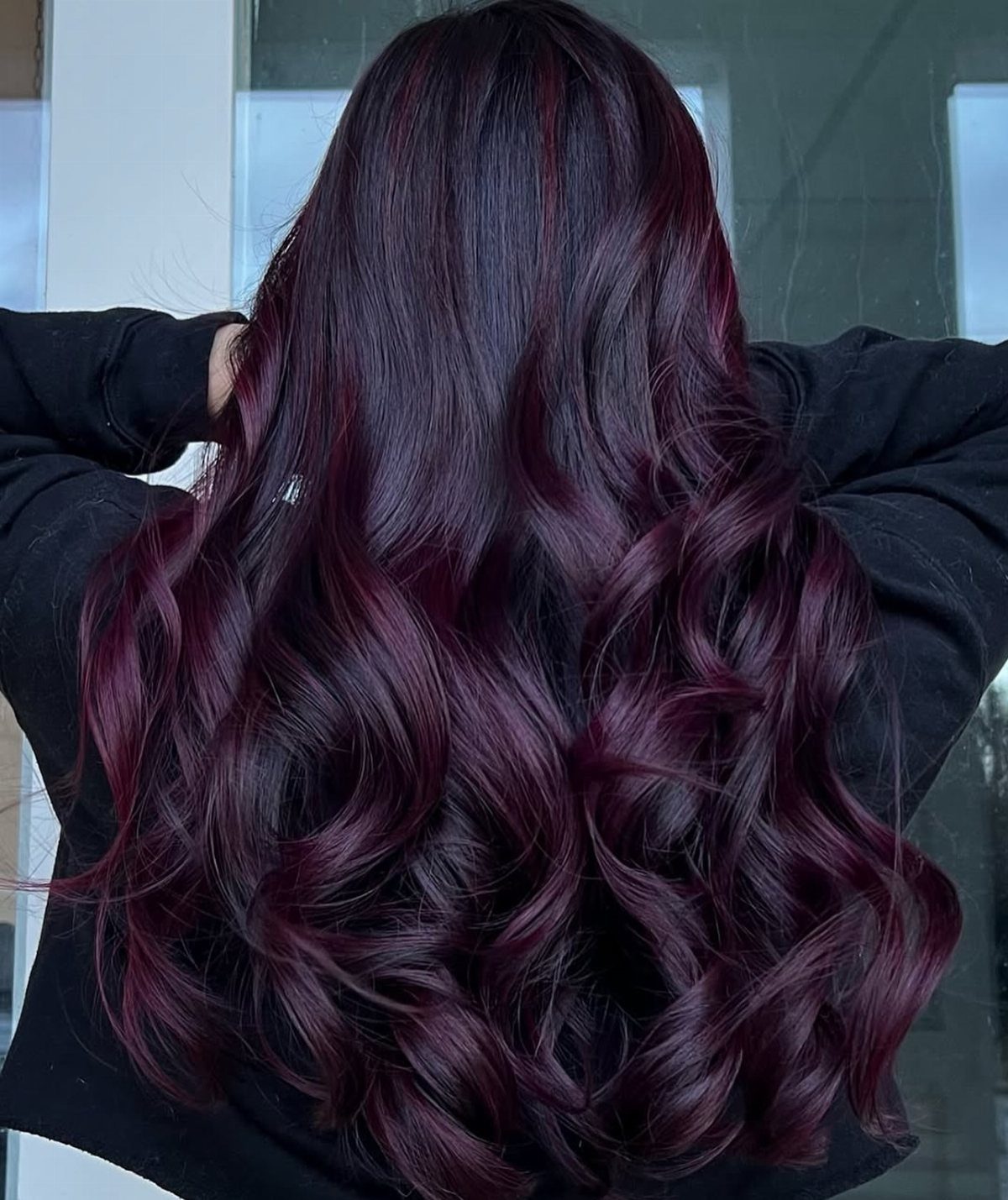 Long wavy merlot and near-black hair with glossy burgundy tones