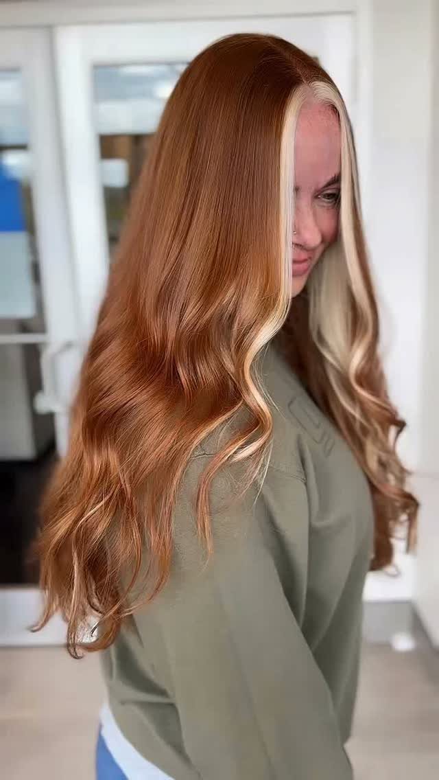 Woman showing long ginger waves with a pale blonde face-framing highlight