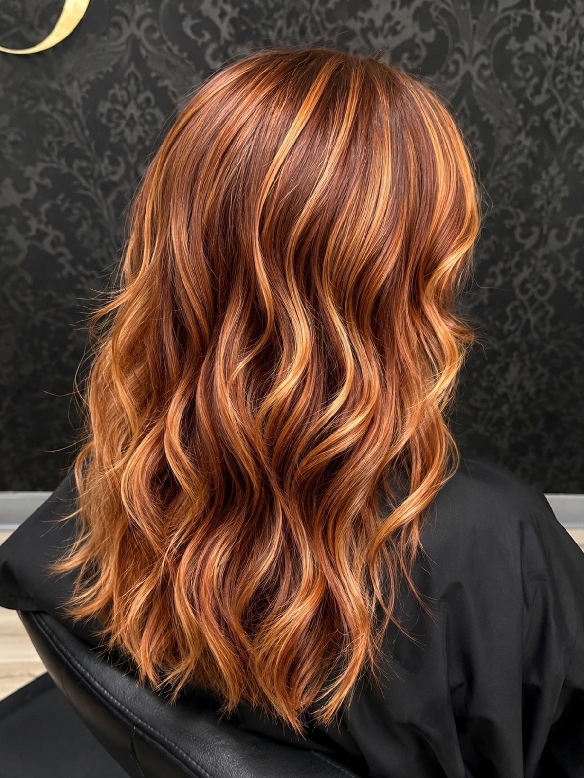 Wavy auburn hair with bright copper ginger highlights throughout