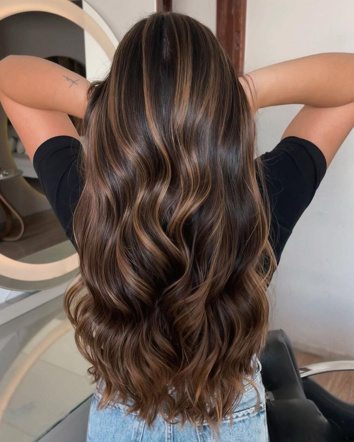Long wavy brown hair with fine sandy golden highlights shown from behind