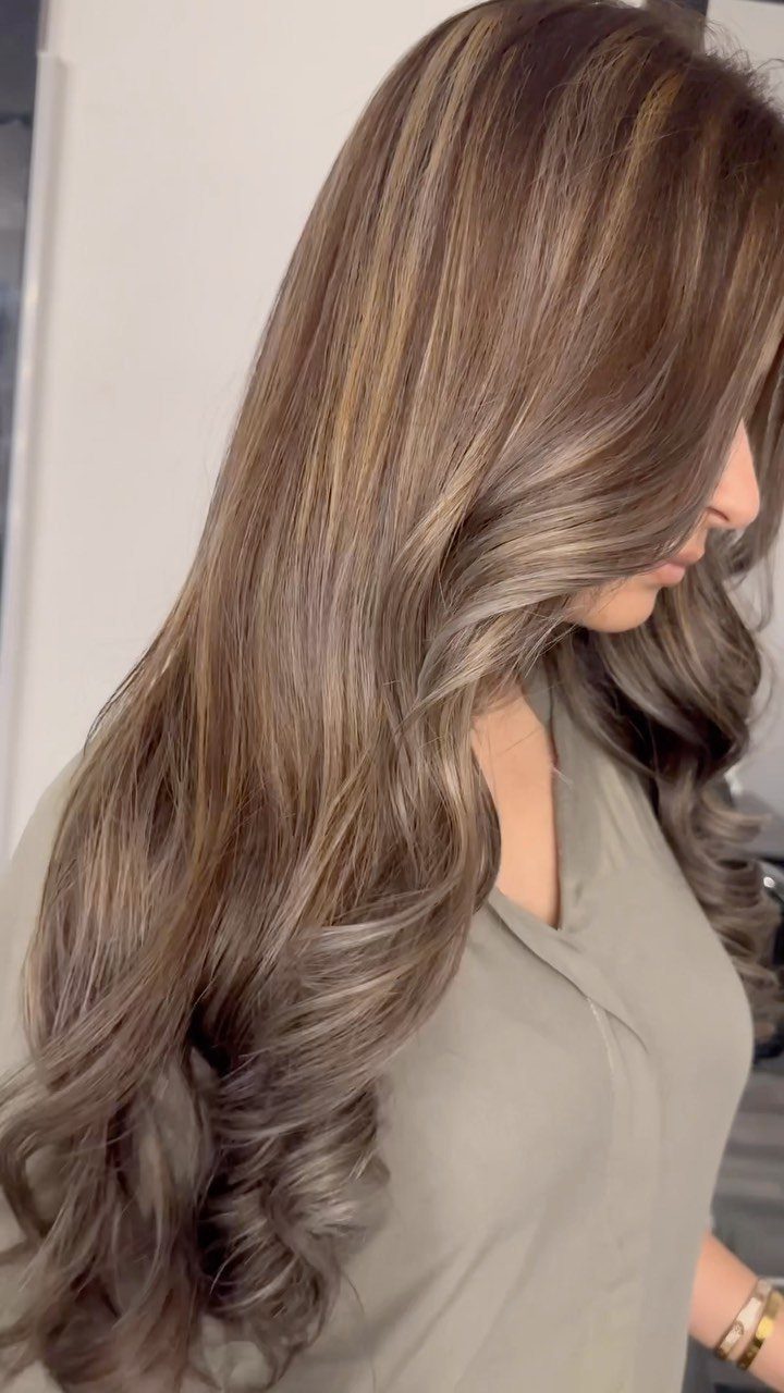 Long wavy ash-brown hair with cool beige caramel highlights