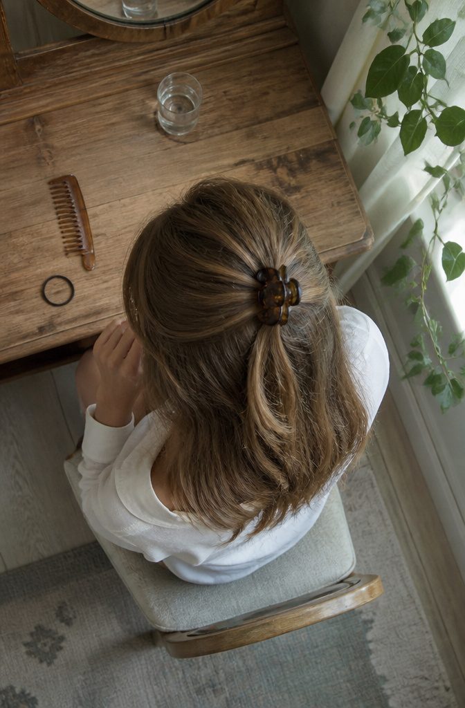 Half-up hairstyle with secured top section and loose layered lengths