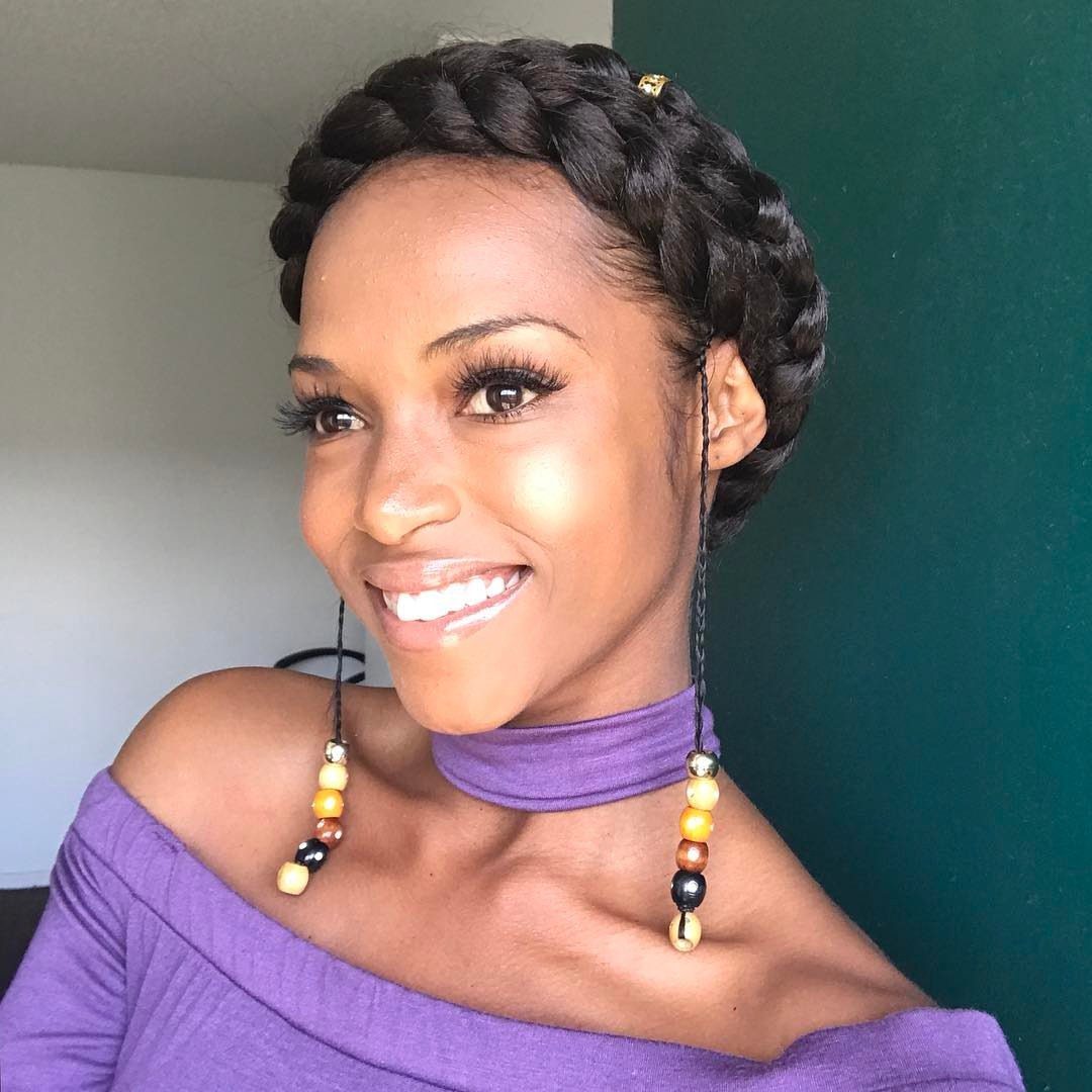 Woman displaying a thick dark halo braid encircling her head