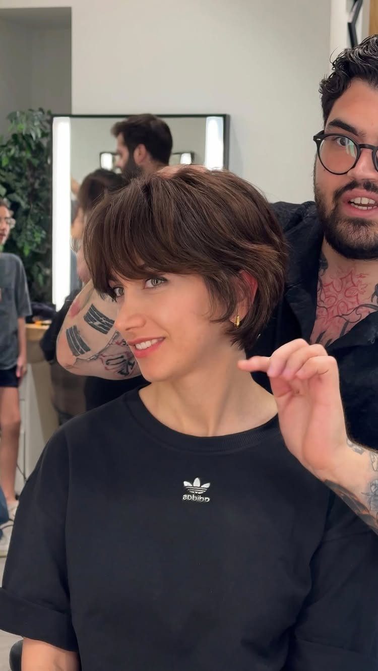 Woman showing a short brown pixie with a long side-swept fringe