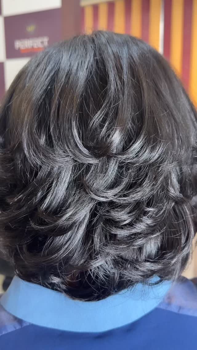 Short dark bob with rounded, tapered layers and curled-under ends
