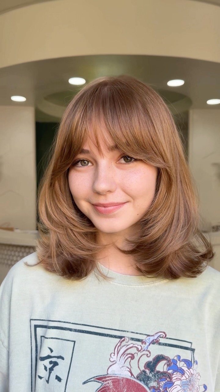 Young woman with medium-length textured layers and feathered ends