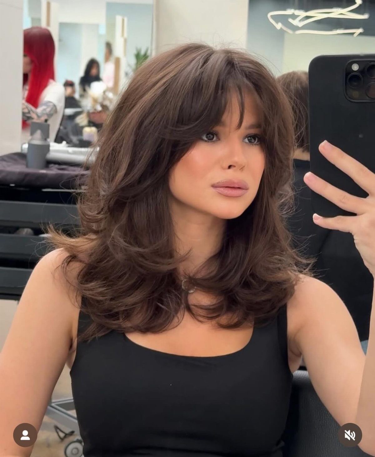 Woman showing layered brown hair with a relaxed, wispy deconstructed fringe