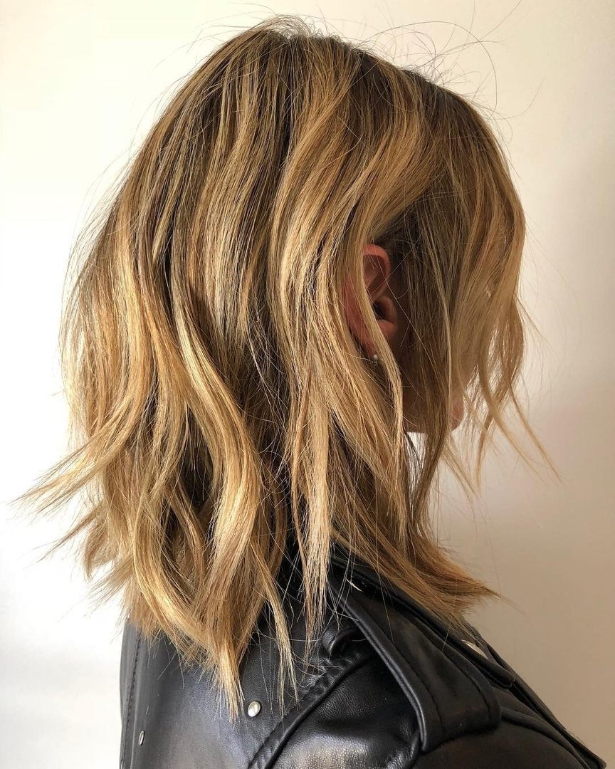 Shoulder-length blonde lob with choppy, textured layers and loose waves
