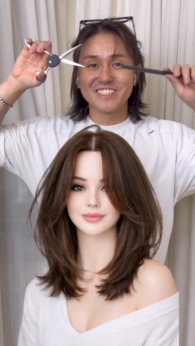 Mannequin with layered brown hair and outward-flipped ends as a stylist holds scissors