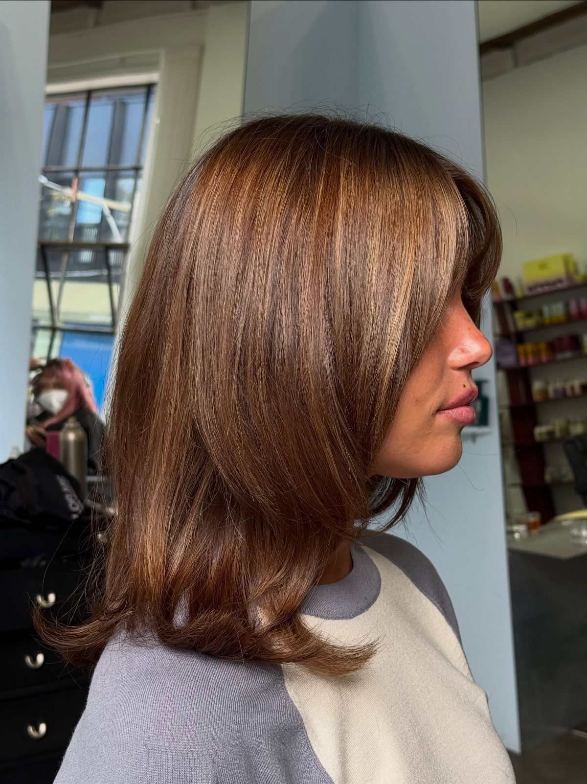 Shoulder-length brown bob with softly curled ends and subtle tonal variation