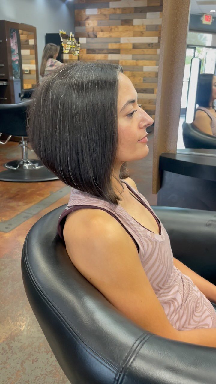 Woman in profile showing a sleek angled bob with longer front pieces