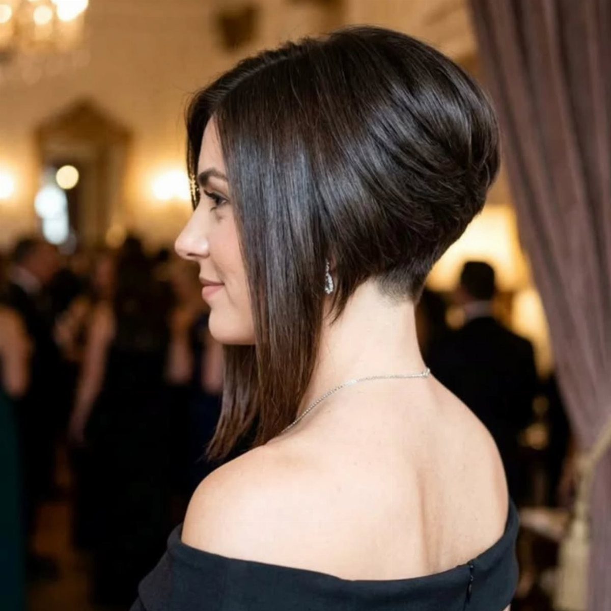 Woman showing a dark graduated bob with short back and long front sections