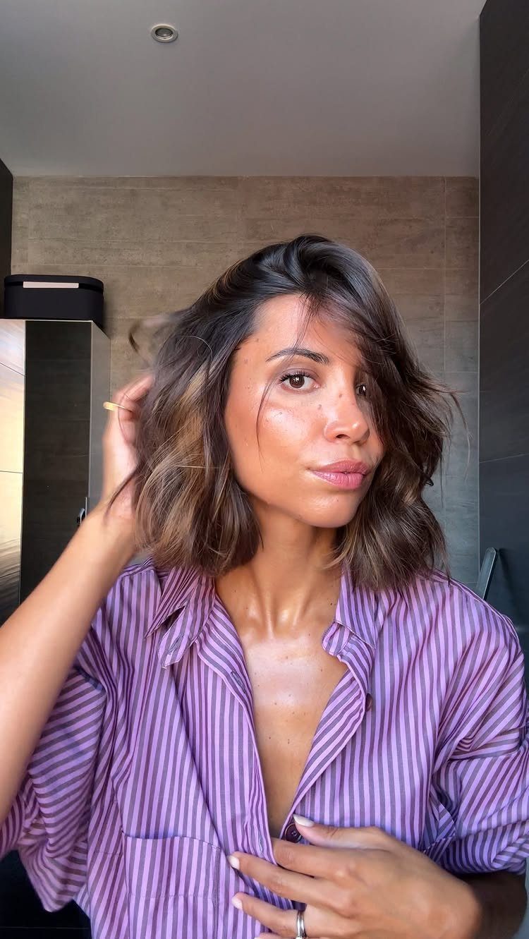 Woman showing a shoulder-length wavy bob with long layers