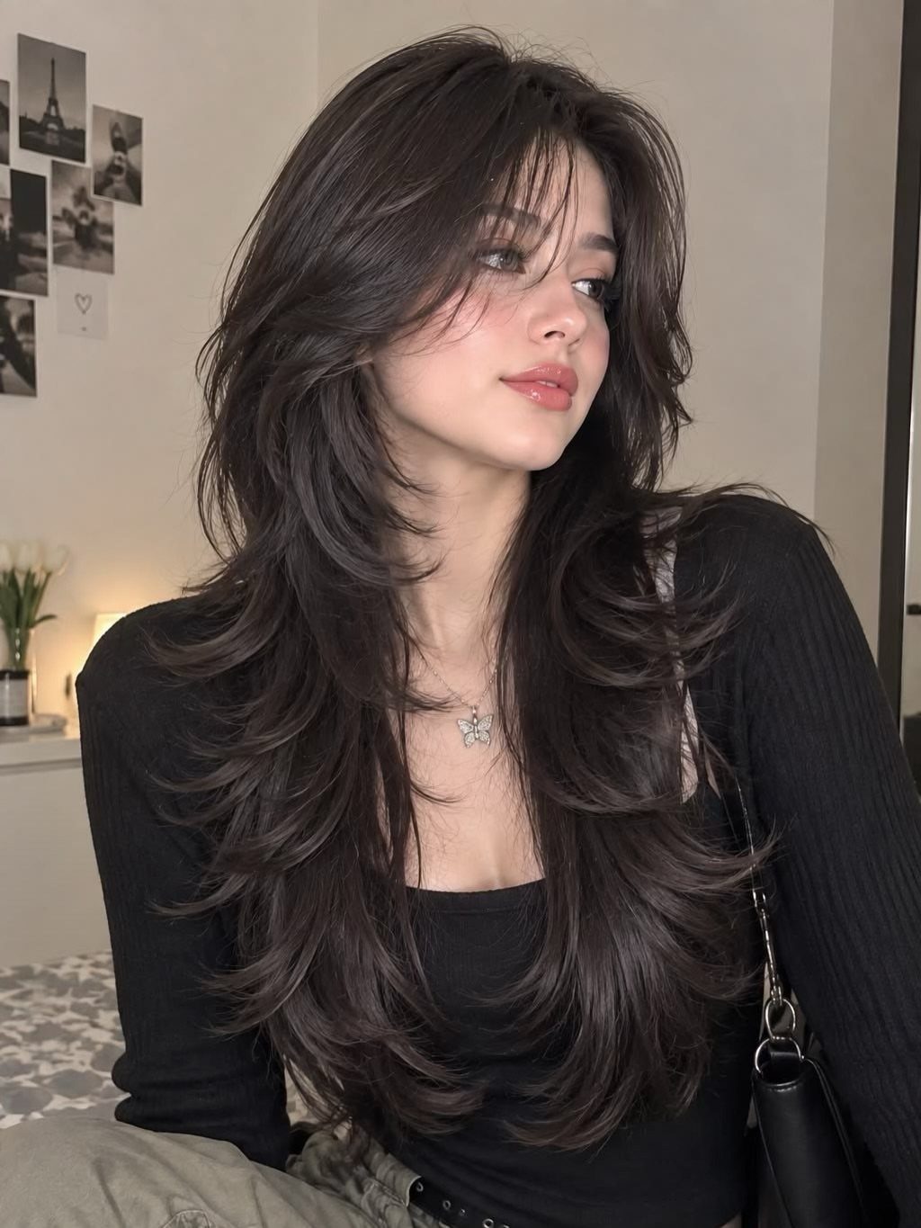 Woman showing a long dark wolf cut with choppy layers and curtain bangs