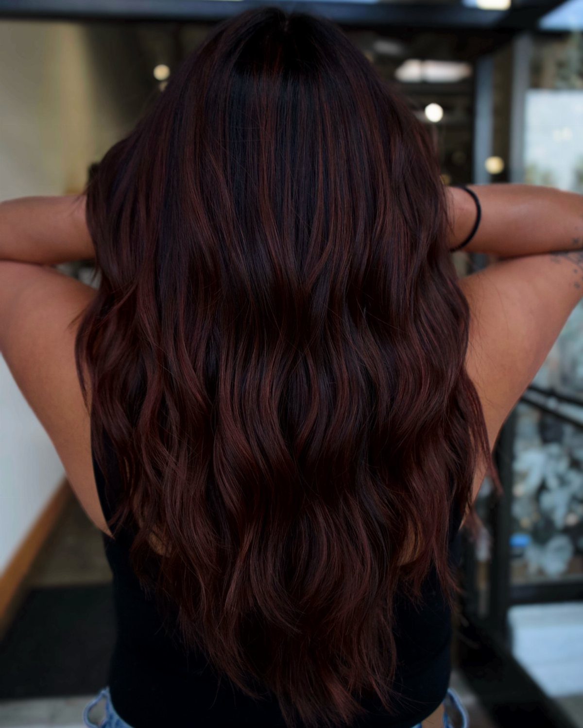 Long wavy espresso brown hair with subtle dark cherry red tones