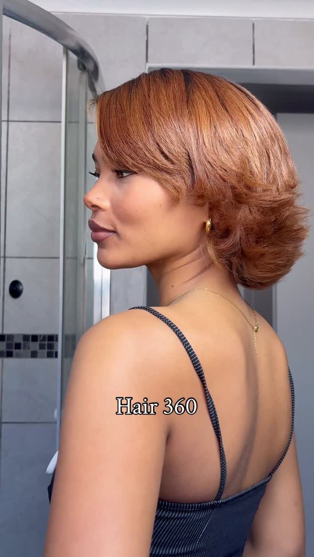 Woman showing a copper bob with layered ends flipped outward at the nape
