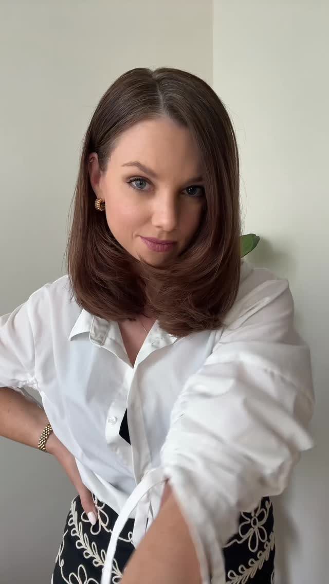 Woman showcasing a shoulder-length dark brown layered bob with curled-under ends